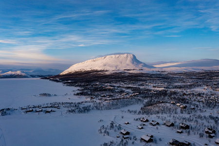 Aerial drone view of the Saanatunturi mountain, in Kilpisjarvi, winter evening, in Lapland