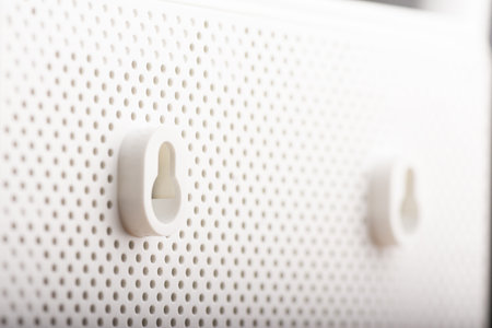 A modern white wireless internet router backside with wall mount placeの写真素材