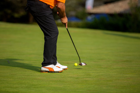 A male playing golf in the fieldの写真素材