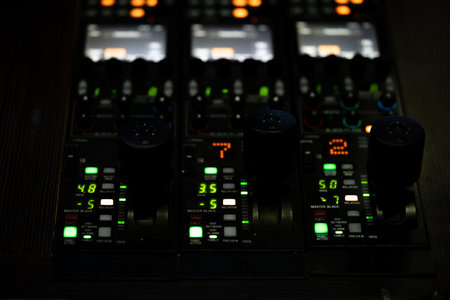 A closeup of lighted mixing console isolated on black backgroundの写真素材