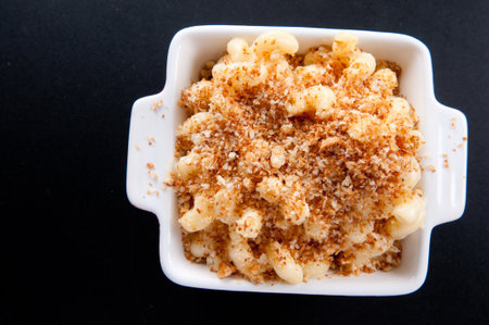 macaroni and cheese noodles in single serving size with breadcrumb toppingの写真素材