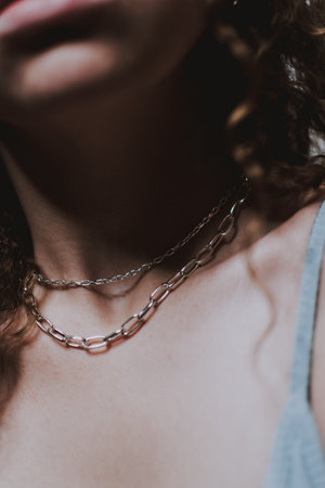 A shallow focus shot ochain necklace on the female neckの写真素材