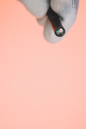 A vertical shot of a rubber insulated cable on a colorful backgroundの写真素材