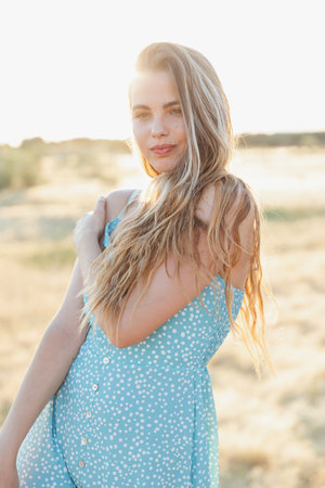 A vertical shot of a young attractive female posing on a sunny dayの写真素材