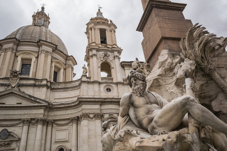 A low-angle shot of the Fiumi Fountain in Piazza Navona in Romeの写真素材