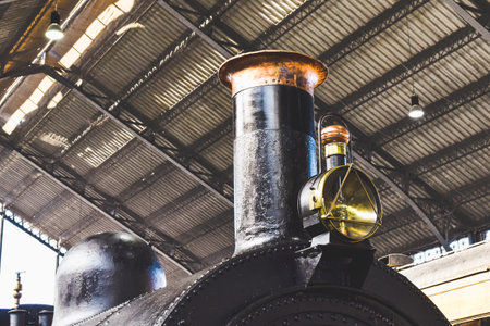 A closeup of the details of an old steam train locomotive with a blurry backgroundの写真素材