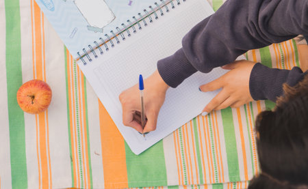 A student studying during the picnic in the park