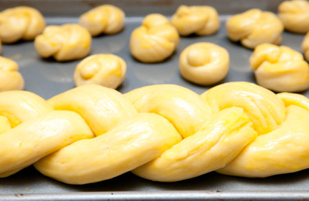 A closeup of raw dough in the form of a braid on a sheet panの写真素材