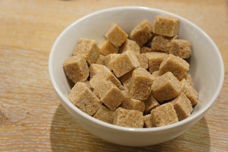 Brown sugar cubes in a white bowlの写真素材