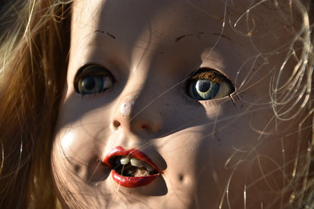 A closeup of a creepy old doll faceの写真素材