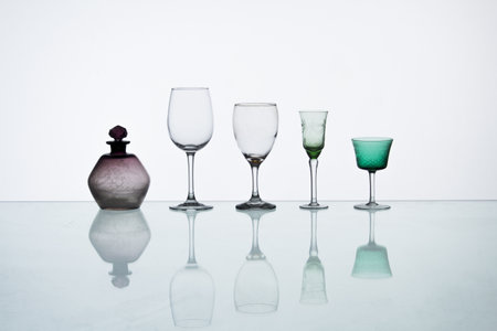 A closeup shot of different glasses reflection on the table backgroundの写真素材