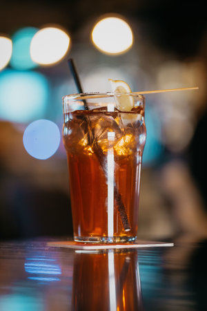 A vertical shot of a refreshing drink with a lemon slice on blurred backgroundの写真素材