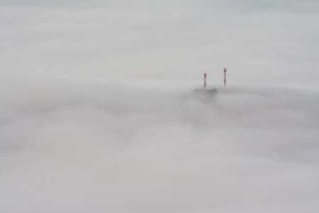 A view of a mountaintop surrounded by fogの写真素材