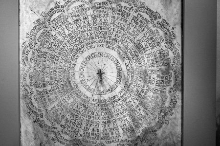 A closeup of a Latin liturgical calendar on a marble grave in Ravenna, Italyの写真素材