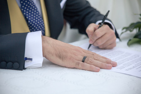 A closeup shot of a businessman signing papers