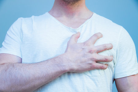 A man standing with his hand on his heartの写真素材