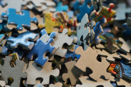 A macro shot of a pile of puzzle pieces