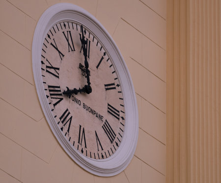 A closeup shot of a clock of the church with a white decorative frameの写真素材