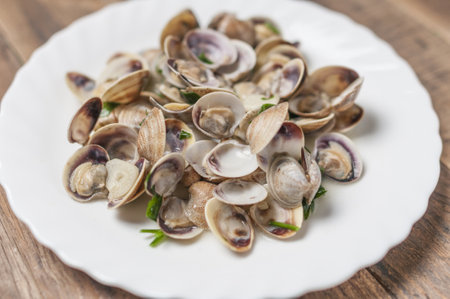 A plate with clams in wine sauce with garlic and parsleyの写真素材
