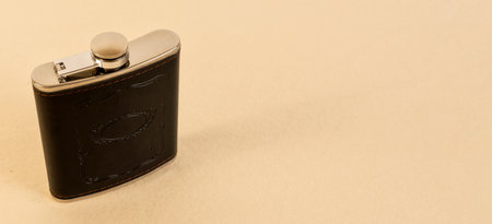 A high angle shot of whiskey flask on an isolated beige backgroundの写真素材