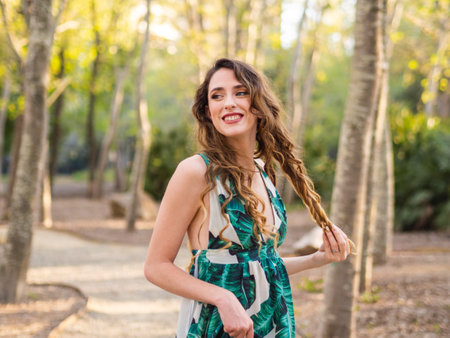 A happy young female enjoying leisure time in a spring park