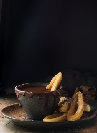 The traditional Spanish churros with hot chocolateの写真素材