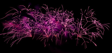 Bright festive fireworks. Light rays on a dark sky background. Abstract rays of light.の写真素材