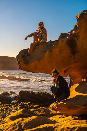 A vertical shot of two women in the Jaizkibel mountain in the town of Pasajesの写真素材