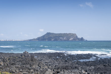 A beautiful shot of a beach with cliffs in the horizonの写真素材