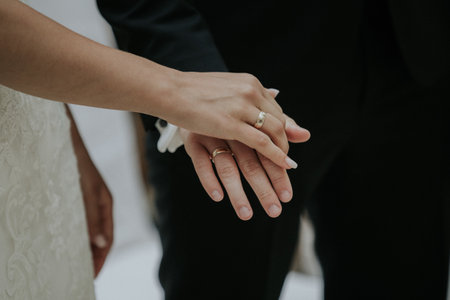 A newlywed couple holding handsの写真素材