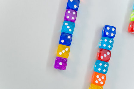 A top view of colorful transparent dice on white background for a copy spaceの写真素材