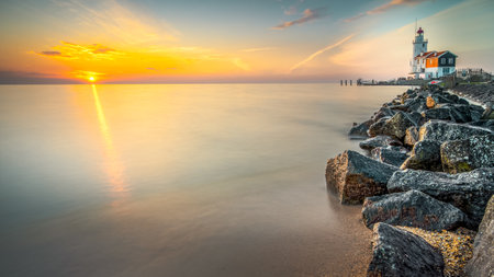 The Horse of Marken lighthouse during sunrise. Marken is a small fishing village on the coastの写真素材