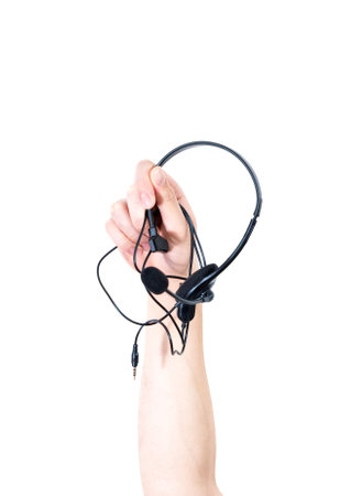 A vertical shot of a raised male arm holding headphones with microphoneの写真素材