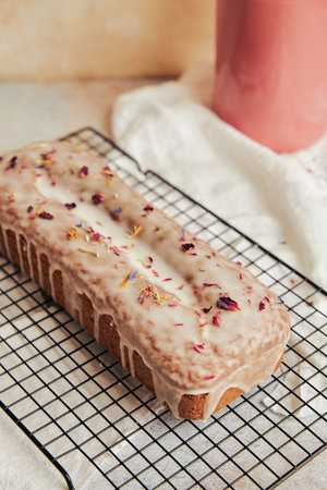 A vertical shot of a delicious citrus cake with flowers on top on a table