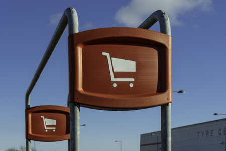 A red trolley bay sign by the storeの写真素材