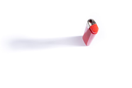 A closeup shot of a red lighter on a white backgroundの写真素材