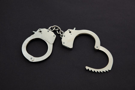 A closeup shot of handcuffs isolated on black background