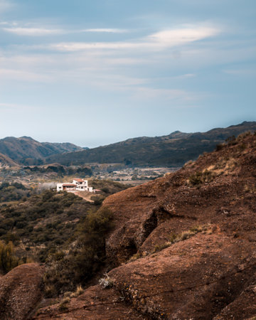 A vertical shot of a house in nature in Cordoba province, Argentina under a blue beautiful skyの写真素材
