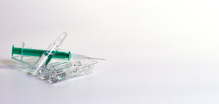 a syringe and ampules on white background - copy spacの写真素材