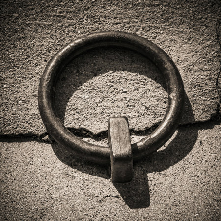 The closeup of iron mooring ring on a dockside, Brittany, France