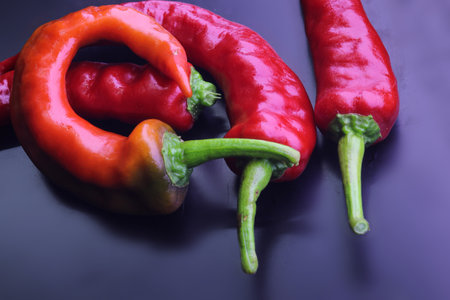 A red chili pepper set isolated on the dark surfaceの写真素材