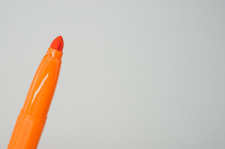 A closeup of an orange marker isolated on light gray backgroundの写真素材