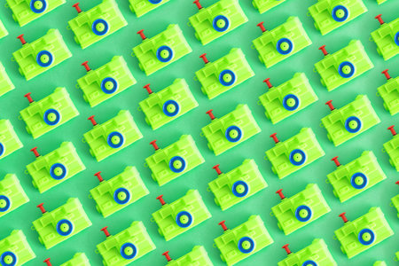 A pattern, Isolated toy camera, green color, on a green background