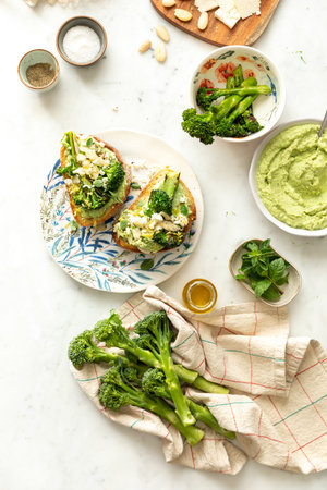 A top view of healthy vegan breakfast with broccoli, egg, sauces, and other ingredientsの写真素材