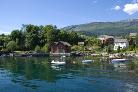 small village with houses and boats at Hardangerfjord, Norway