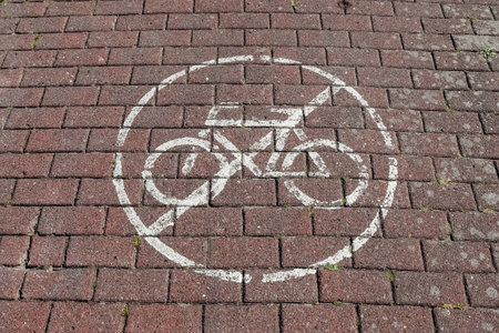 A closeup shot of a sign "no ride a bicycle" on the brick surfaceの写真素材