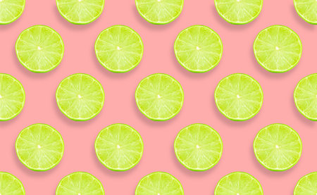 A top view of a lime slice pattern on a pink surface - perfect for wallpapersの写真素材