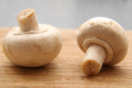 A closeup shot of mushrooms in a wooden tabの写真素材