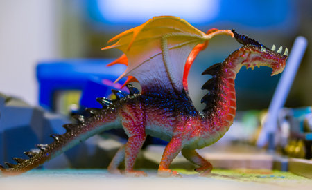 Plastic toy dragon with wings in soft focusの写真素材