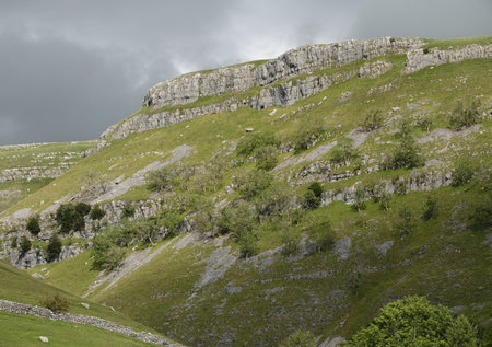 A view of meadows on a rocky mountainsideの写真素材